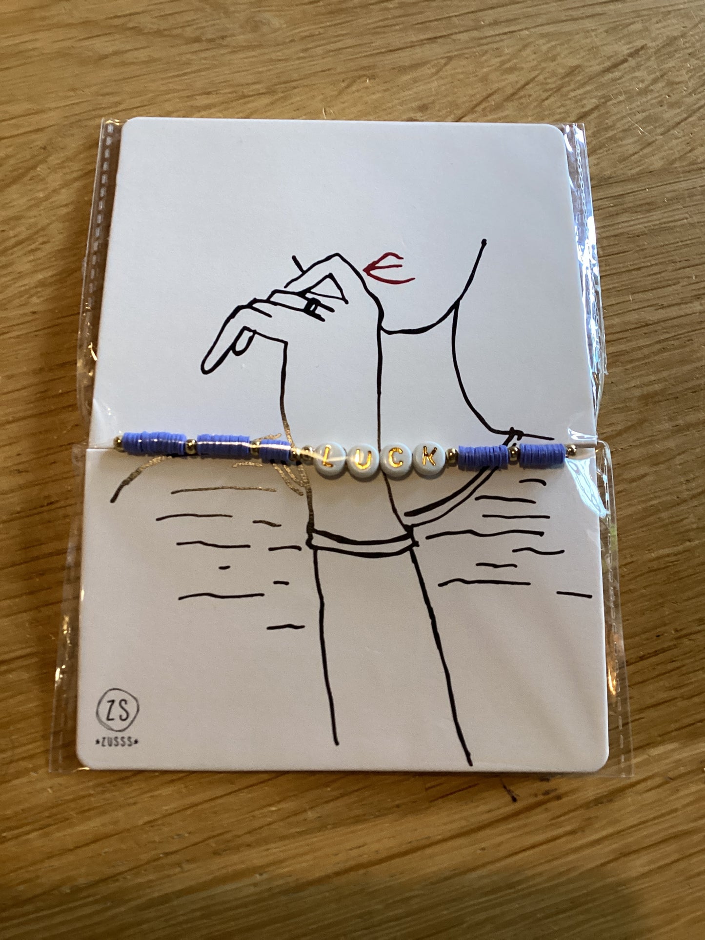 Zusss kralenarmband met tekst luck lila