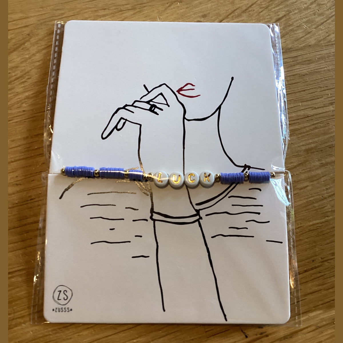 Zusss kralenarmband met tekst luck lila